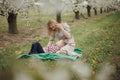 Mom with her son in a blooming garden. Walk with baby in nature in spring. Garden in Grojcu