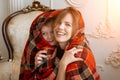 Mom and her young son wrapped themselves in a blanket. Spiritual kinship, comfort