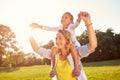 Mom holding daughter on shoulders Royalty Free Stock Photo