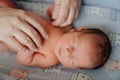 Mom holding hands of newborn. children sleeps. cosmetics for skin care