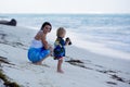 Mom, holding little toddler boy with binoculars, observing dolphins Royalty Free Stock Photo