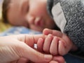 Mom holds the baby`s hand close-up. child 0-1 years old Royalty Free Stock Photo