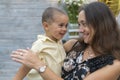 Mom holds a child in her arms. A happy family. Young mother holding her baby in her arms and stroked my mother`s child Royalty Free Stock Photo