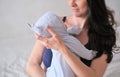 Mom holds her newborn baby in her arms. Portrait of a boy or girl close-up. Royalty Free Stock Photo