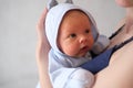 Mom holds her newborn baby in her arms. Portrait of a boy or girl close-up Royalty Free Stock Photo