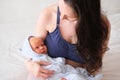 Mom holds her newborn baby in her arms. Portrait of a boy or girl close-up Royalty Free Stock Photo
