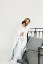 Mom holds her one-year-old daughter in her arms, wrapped in a blanket Royalty Free Stock Photo