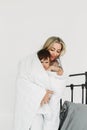 Mom holds her one-year-old daughter in her arms, wrapped in a blanket Royalty Free Stock Photo