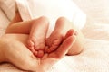 Mom holds the legs of cute newborn little baby Royalty Free Stock Photo