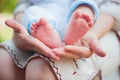 Mom holds the legs of a small child Royalty Free Stock Photo