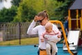 Young mother with children on playground