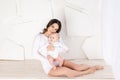 Mom holds newborn baby in her arms at home, happy loving family concept, mother`s day Royalty Free Stock Photo