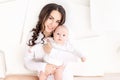 Mom holds newborn baby in her arms at home, happy loving family concept, mother`s day Royalty Free Stock Photo