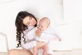 Mom holds newborn baby in her arms at home, happy loving family concept, mother`s day Royalty Free Stock Photo