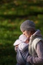 Mom hugging baby outdoors