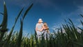 Mom hugs daughter, stand on a beautiful green meadow against a clear blue sky Royalty Free Stock Photo