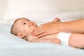 Mom hugs with her newborn baby in bed