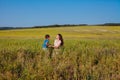 mom hugs her son in the field on a walk Royalty Free Stock Photo