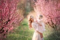 Mom with an infant in the rose garden with flowers trees Royalty Free Stock Photo