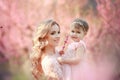 Mom with an infant in the rose garden with flowers trees Royalty Free Stock Photo