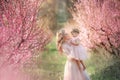 Mom with an infant in the rose garden with flowers trees Royalty Free Stock Photo