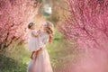 Mom with an infant in the rose garden with flowers trees Royalty Free Stock Photo