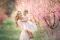 Mom with an infant in the rose garden with flowers trees Royalty Free Stock Photo