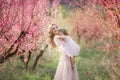 Mom with an infant in the rose garden with flowers trees Royalty Free Stock Photo