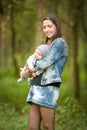 Mom in jeans with a baby. mother and her little daughter park