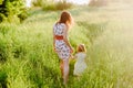 Mom keeps daughter's hand and walks the walk on the nature in sunset light Royalty Free Stock Photo