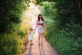Mom keeps daughter's hand and walks the walk on the nature in sunset light Royalty Free Stock Photo