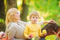Mom and kid boy relaxing while hiking forest. Family picnic. Mother pretty woman and little son relaxing forest picnic Royalty Free Stock Photo
