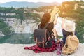 Mom and kid holding maps and travel backpacks sitting victorious facing on the grand canyon for education nature. Royalty Free Stock Photo