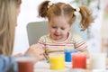 Cute mother teach her daughter kid to paint Royalty Free Stock Photo