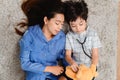 Mom and kid playing as doctor together in living room. Lifestyle and family activity. Asian mother with son