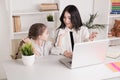 Mom and kid using laptop together and teaching in internet. Royalty Free Stock Photo