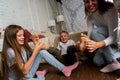 Mom and kids have fun in the bedroom and tickle each other& x27;s feet. The older sister helps tickle the legs of the younger