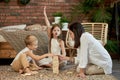 Mom and kids play squirl tower. Woman girl and boy play family puzzle game. Family day off Royalty Free Stock Photo