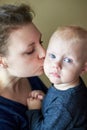 Mom kisses her little blue-eyed son, portrait Royalty Free Stock Photo