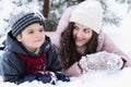 Mom kissing little stylish smiling happy cute boy, kid. Lovely family walking,activity in beautiful winter forest, park.Trees Royalty Free Stock Photo