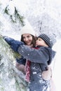 Mom kissing little stylish smiling happy cute boy, kid. Lovely family walking,activity in beautiful winter forest, park.Trees Royalty Free Stock Photo