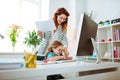 Red-haired mom laughing while teaching her girl using keyboard Royalty Free Stock Photo