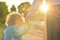 Mom leads her little daughter by the hand, walking at sunset in the evening Royalty Free Stock Photo