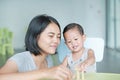 Mom and little baby boy playing wood blocks tower game for Brain and Physical development skill in a classroom. Focus at children Royalty Free Stock Photo