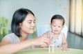 Mom and little baby boy playing wood blocks tower game for Brain and Physical development skill in a classroom. Focus at children Royalty Free Stock Photo