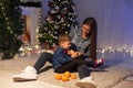 Mom with little boy Christmas tree with new year holiday gifts Royalty Free Stock Photo