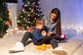 Mom with little boy Christmas tree with new year holiday gifts Royalty Free Stock Photo