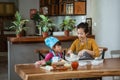 Mom and little cute girl in chef clothes making homemade pizza Royalty Free Stock Photo