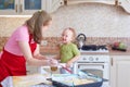 Mom and little daughter cook pies in the kitchen at home Royalty Free Stock Photo