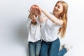 Mom and little daughter looking at each other, happy family, isolated background, cute and beautiful Royalty Free Stock Photo